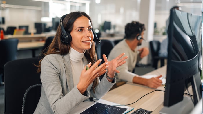 Call center female agent answering incoming calls with a headset