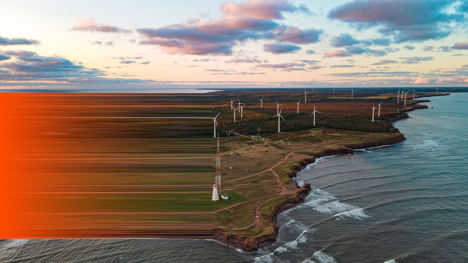 ENVATO_Beautiful aerial view of an island with wind turbines under the sunset sky with clouds By wirestock_L2