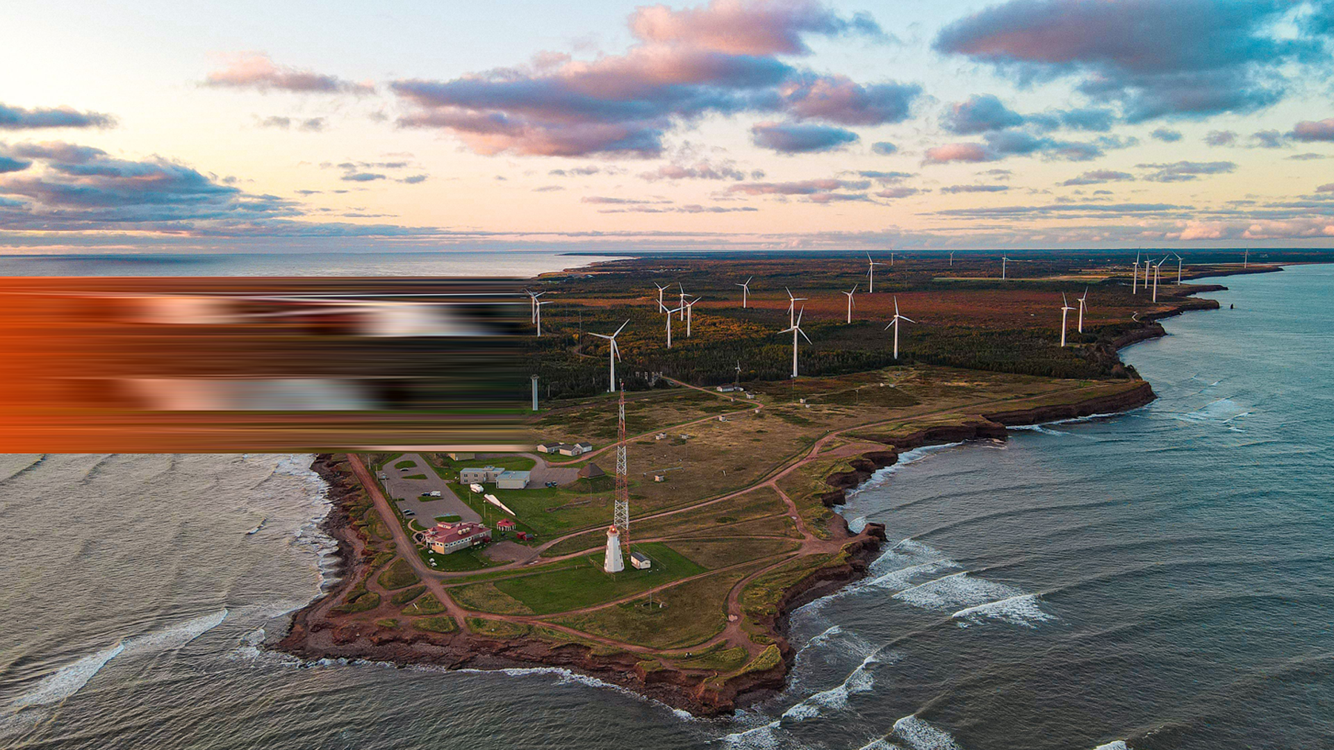 ENVATO_Beautiful aerial view of an island with wind turbines under the sunset sky with clouds By wirestock_L4