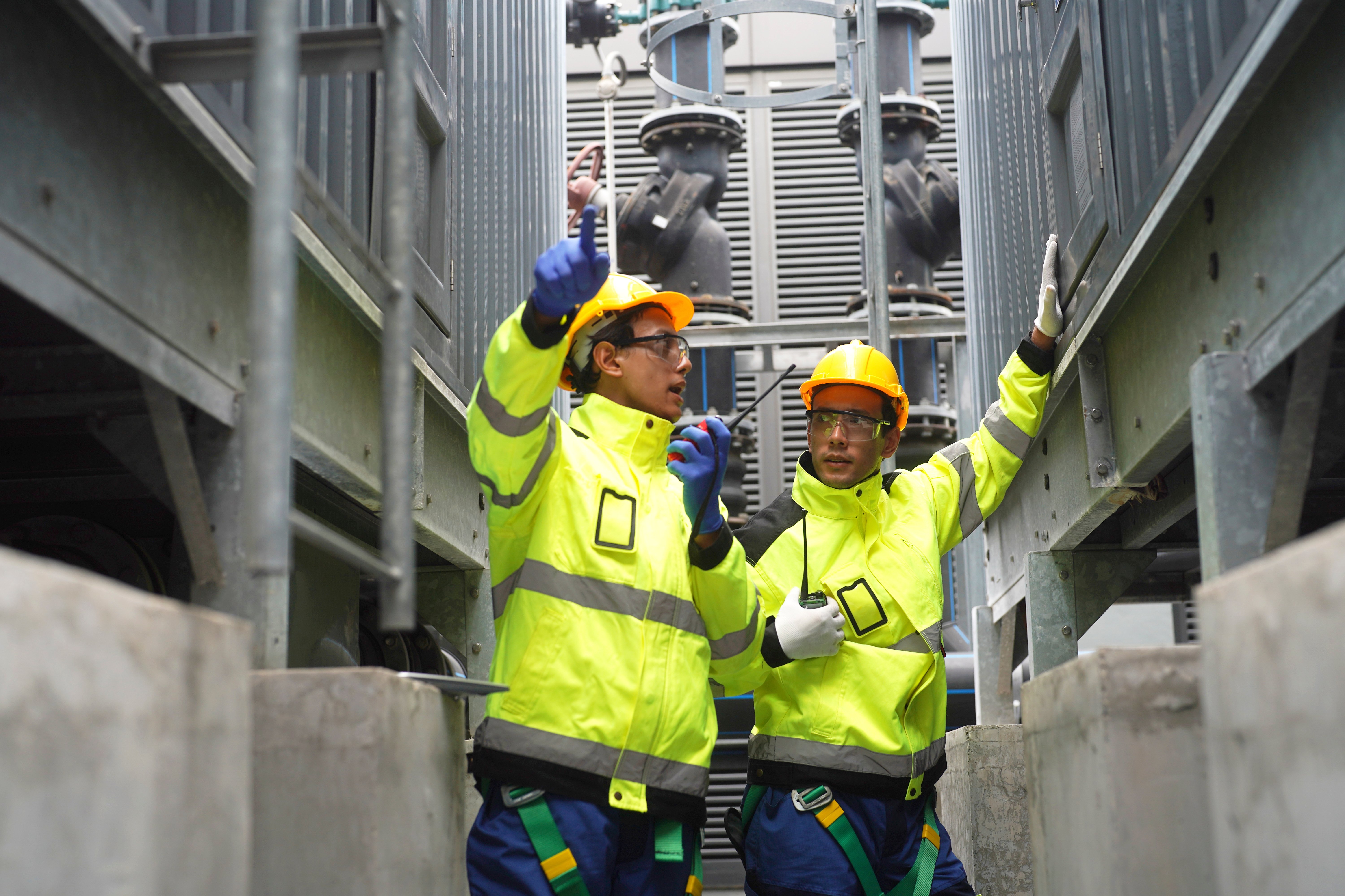 two-workers-inspect-electrical-equipment-in-a-powe-2025-08-11-11-32-23-utc