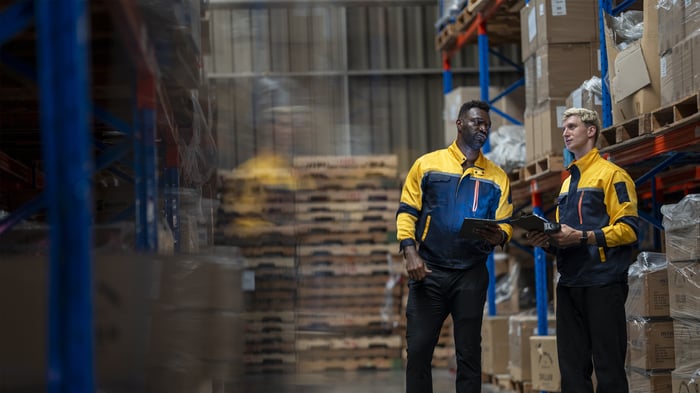 A team of engineers inspects the warehouse in a large storage warehouse.