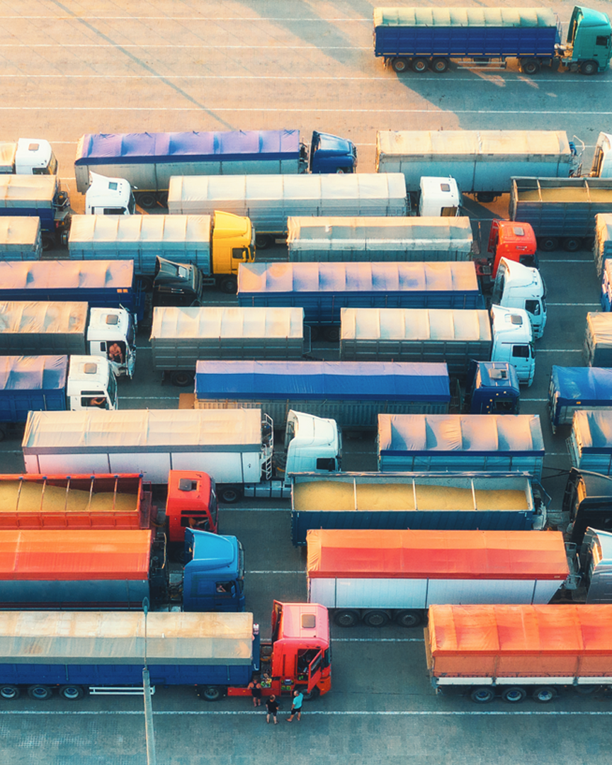 Aerial view of colorful trucks in terminal at sunrise in summer_L1-1
