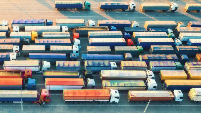 Aerial view of colorful trucks in terminal at sunrise in summer
