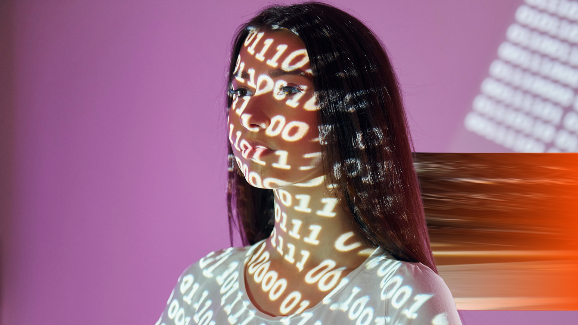 envato_Binary machine code. Beautiful young woman is in projector neon lights in the studio By mstandret_L1