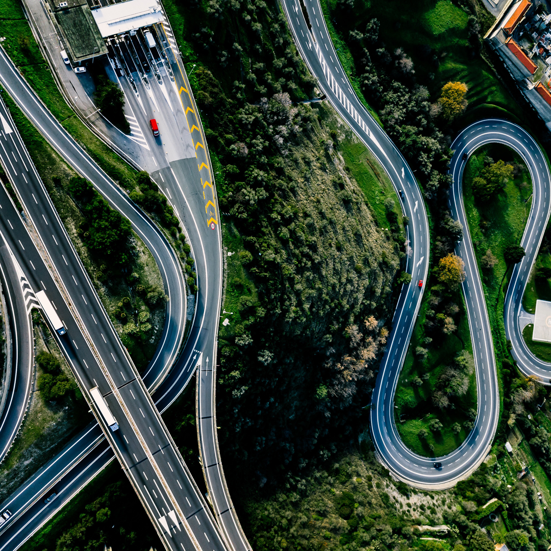 Aerial view of highway, expressway and motorway with a toll payment point in Italy