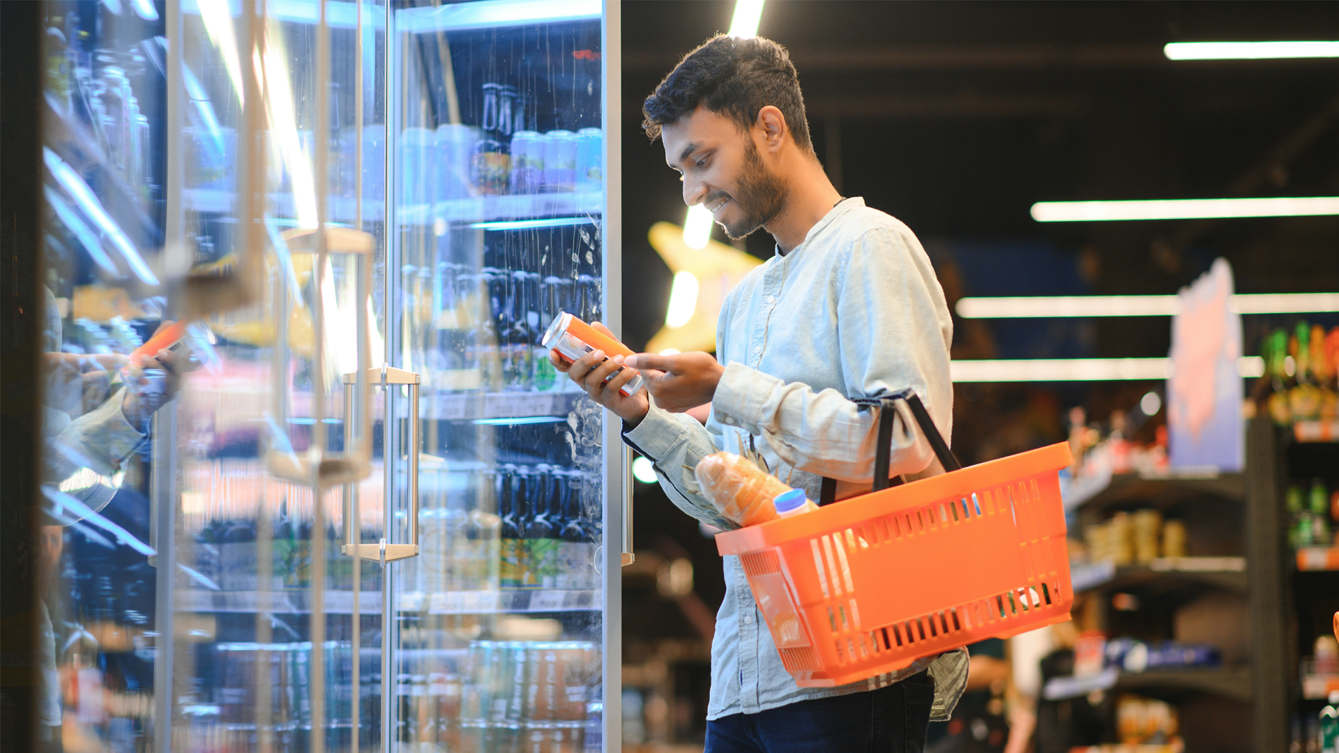 ENVATO_Portrait of happy Indian man standing in front of the product counter in a grocery store. By sedrik2007_L1