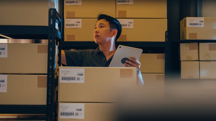 Envato_Asian man use barcode scanner scan box in shelf and put data in digital tablet cut stock online. By Tirachard