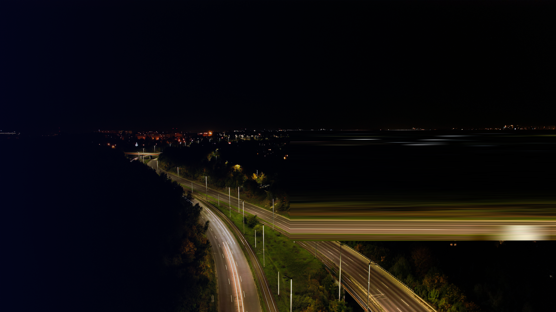 AWV_Top down view to road. Romantic night aerial photo of cars traveling. The light on the road at night By yanishevskaanna_envato