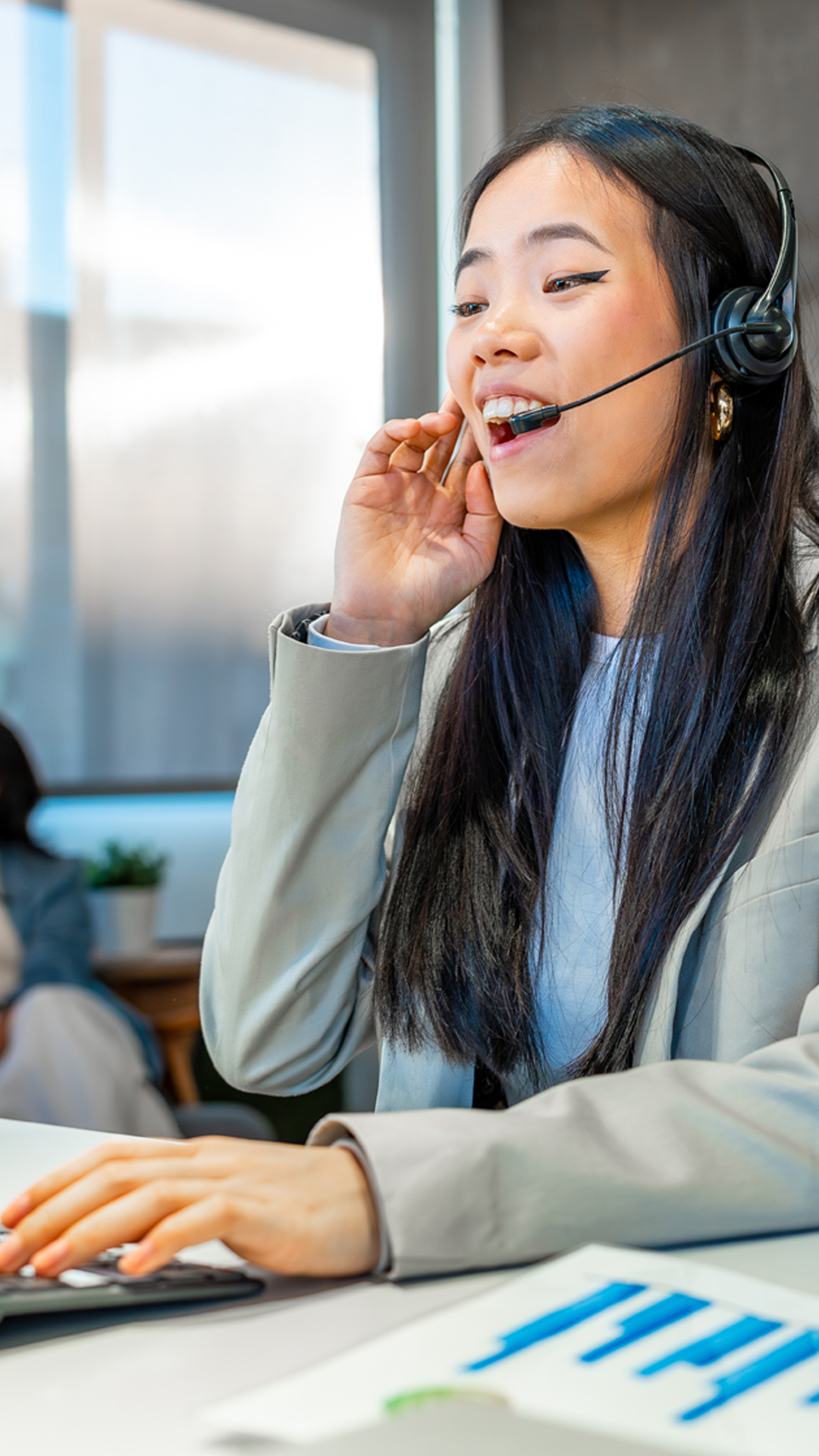 Asian businesswoman working with headset in coworking office
