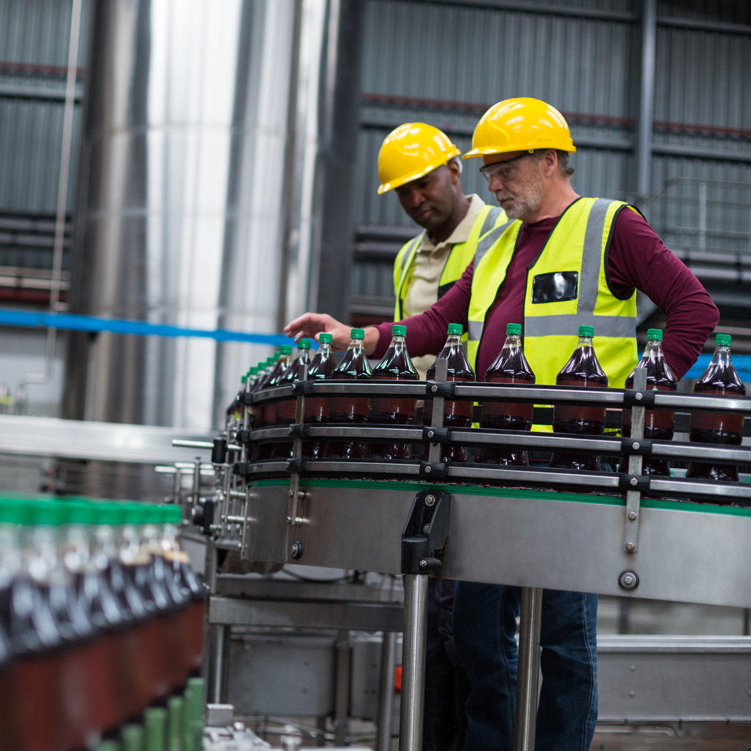 Envato_Factory workers monitoring cold drink bottles at drinks production plant By Wavebreakmedia_SQ0