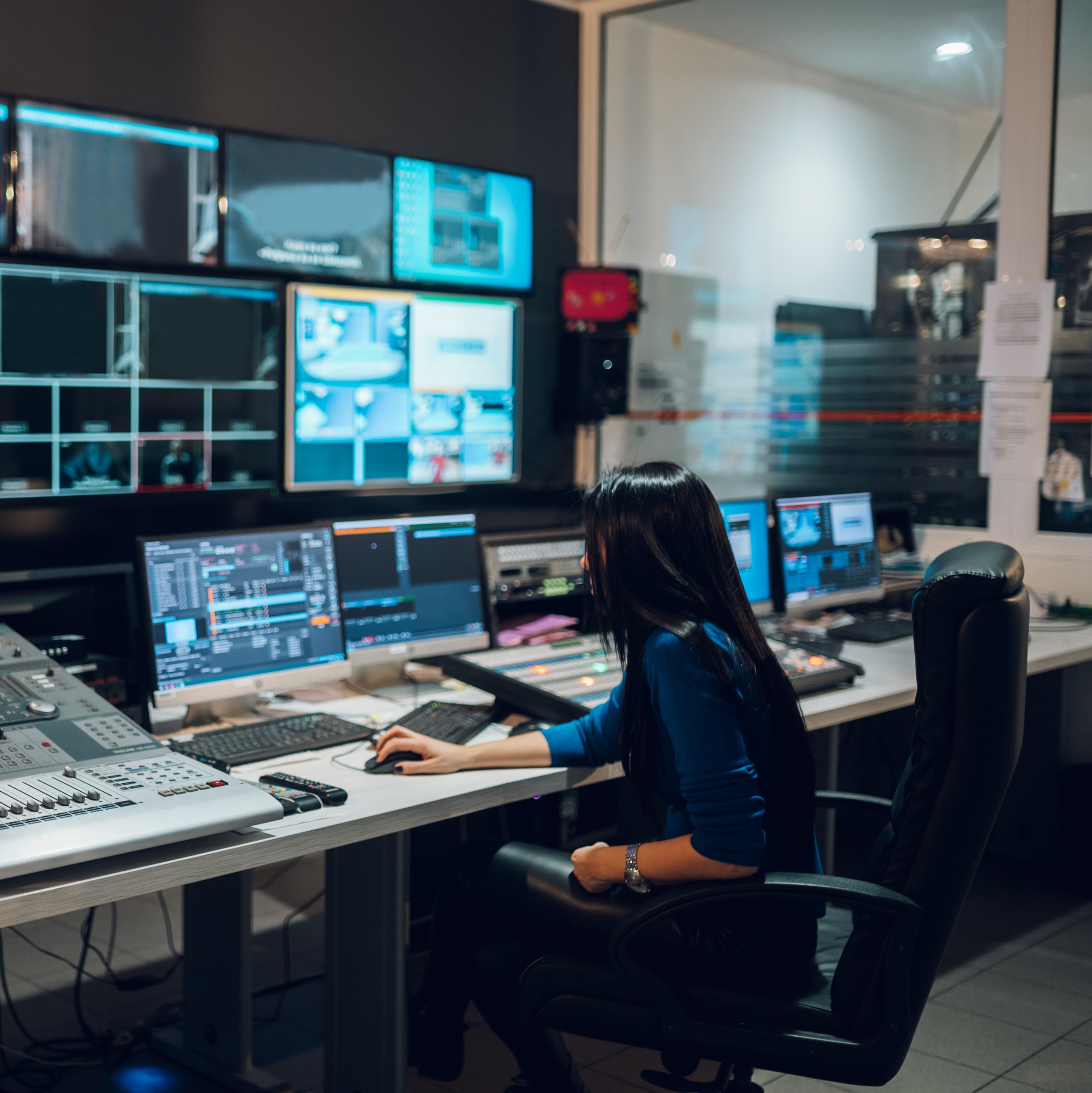 middle-aged-woman-using-equipment-in-control-room-2025-04-01-13-06-10-utc