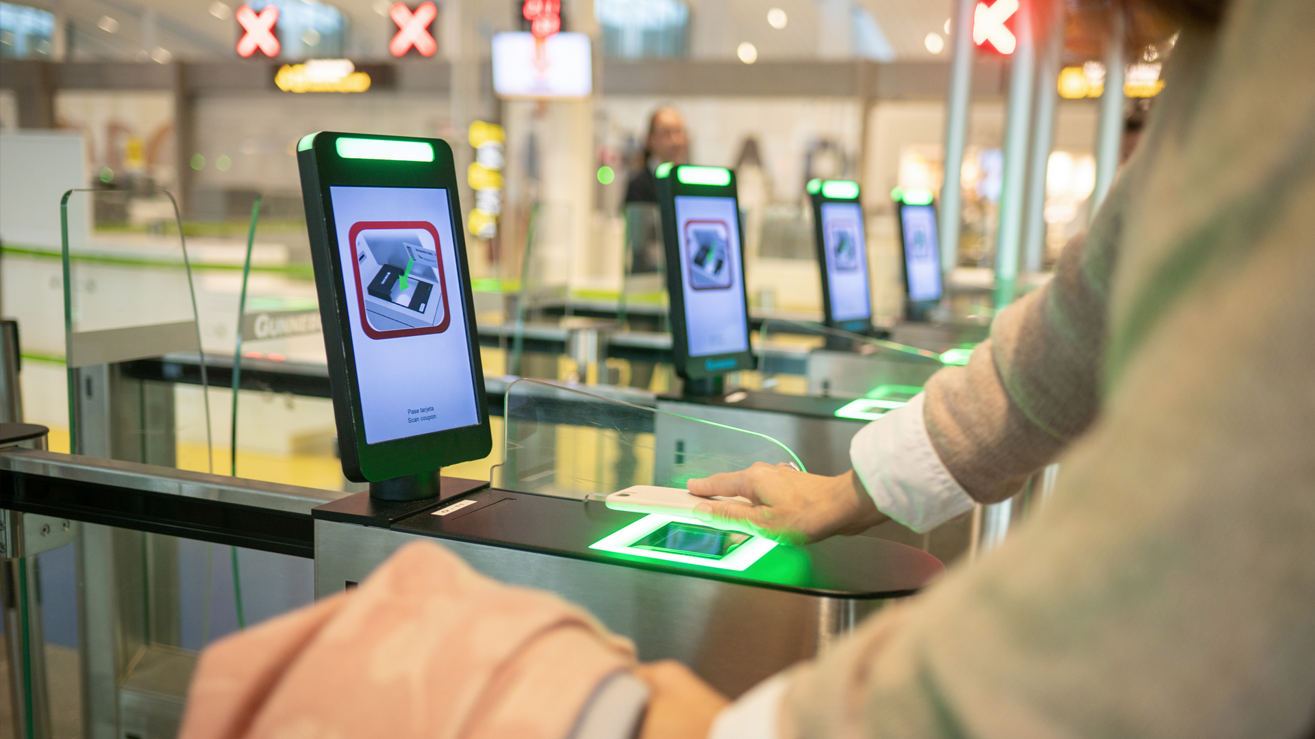 envato_Crop woman using smartphone while scanning info into smart gate pass in airport By GabiStock_L0
